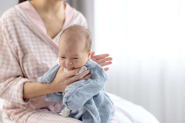 Some moms find that sitting their baby on their lap is the ideal newborn burping position to see their baby better.
