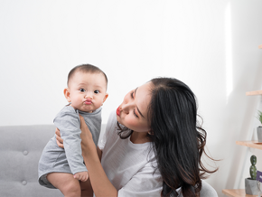 Asian mom playfully imitates her 1-year-old baby's pouting lips Asian mom playfully imitates her 1-year-old baby's pouting lips