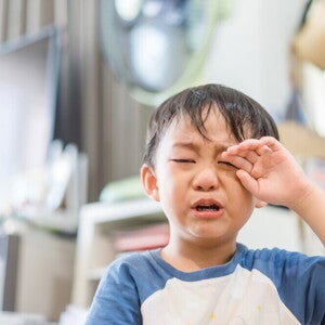 Young Asian boy crying