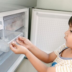 Young Asian boy looking for ice to eat, experiencing pica, one of the 5 weird signs of iron deficiency in kids.